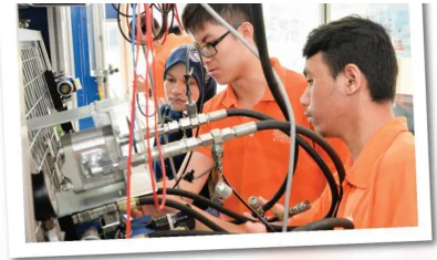 Learners exploring technical equipment in an engineering workspace