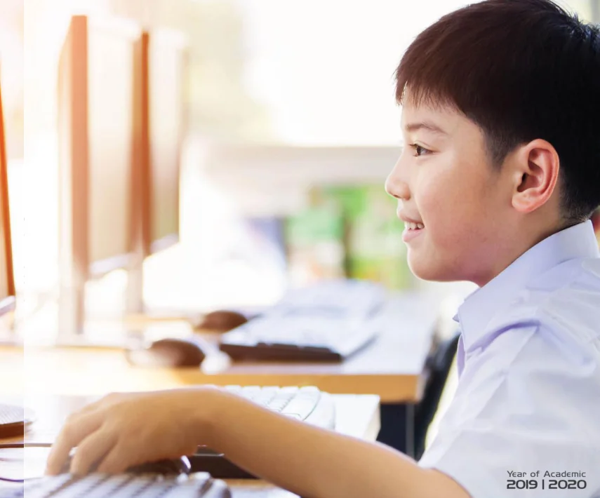 Young student learning using a computer