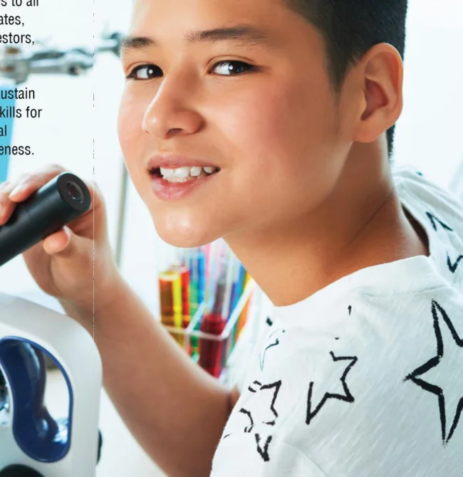 Student exploring science using a microscope